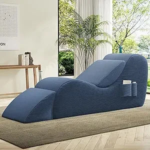 Blue lounge intimacy chair in a modern living room with large windows and plants.